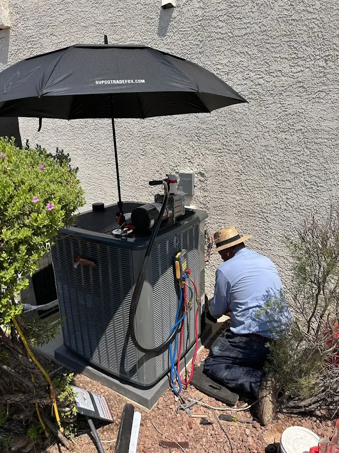 HVAC technician performing outdoor AC maintenance in Vancleave