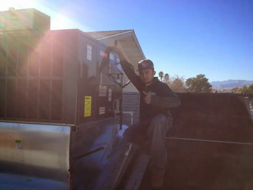 HVAC technician performing HVAC Inspection on a rooftop unit in Vancleave